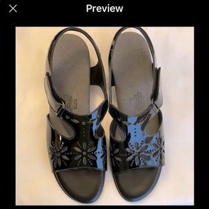 SAS SUNBURST BLACK PATENT CUT OUT SANDALS.…